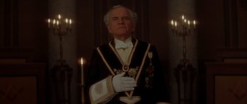 Movie still from “From Hell” (2001), directed by Allen Hughes – An older man in a masonic outfit standing in front of candles; Close Up shot, Low angle