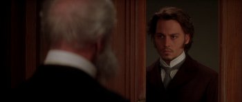 Movie still from “From Hell” (2001), directed by Allen Hughes – Johnny depp looking in the mirror in front of a mirror; Close Up shot, Over the shoulder angle