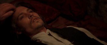 Movie still from “From Hell” (2001), directed by Allen Hughes – A person wearing a suit and tie; Close Up shot, High angle