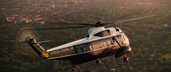 Movie still from “Frost/Nixon” (2008), directed by Ron Howard – A helicopter flying in the air over a city; Extreme Wide shot, Low angle