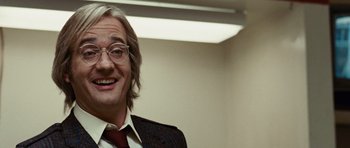 Movie still from “Frost/Nixon” (2008), directed by Ron Howard – A person wearing a suit and tie; Close Up shot, Low angle