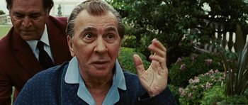 Movie still from “Frost/Nixon” (2008), directed by Ron Howard – An older man with a surprised look on his face; Close Up shot, Over the shoulder angle