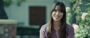 Movie still from “Frost/Nixon” (2008), directed by Ron Howard – A woman with long brown hair smiles for the camera; Close Up shot, Over the shoulder angle