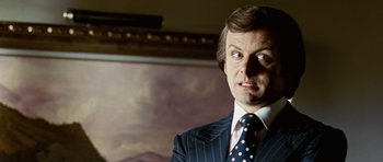 Movie still from “Frost/Nixon” (2008), directed by Ron Howard – A person wearing a suit and a tie; Close Up shot, Low angle