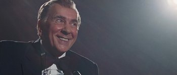 Movie still from “Frost/Nixon” (2008), directed by Ron Howard – An older man in a tuxedo smiling for the camera; Close Up shot, Low angle