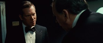 Movie still from “Frost/Nixon” (2008), directed by Ron Howard – A man in a suit and tie talking to another man in a suit and tie; Close Up shot, Over the shoulder angle