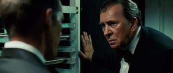 Movie still from “Frost/Nixon” (2008), directed by Ron Howard – An older man looking at a younger man in front of a window; Close Up shot, Over the shoulder angle