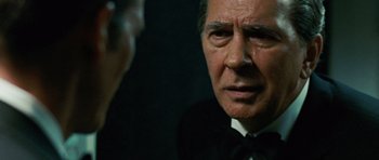 Movie still from “Frost/Nixon” (2008), directed by Ron Howard – An older man wearing a suit and tie; Close Up shot, Over the shoulder angle
