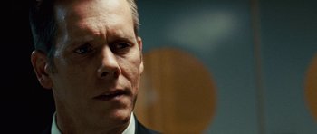 Movie still from “Frost/Nixon” (2008), directed by Ron Howard – A person wearing a suit and tie; Close Up shot, Over the shoulder angle
