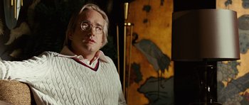 Movie still from “Frost/Nixon” (2008), directed by Ron Howard – A man in a white sweater with glasses; Close Up shot, Low angle