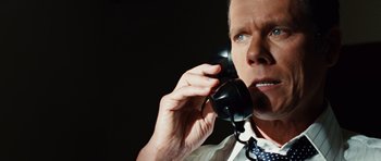Movie still from “Frost/Nixon” (2008), directed by Ron Howard – An older man talking on a black phone; Close Up shot, Low angle
