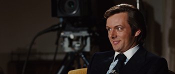 Movie still from “Frost/Nixon” (2008), directed by Ron Howard – A person wearing a suit and tie; Close Up shot, Over the shoulder angle