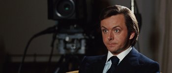 Movie still from “Frost/Nixon” (2008), directed by Ron Howard – A person wearing a suit and tie; Close Up shot, Over the shoulder angle