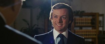 Movie still from “Frost/Nixon” (2008), directed by Ron Howard – A person wearing a suit and tie; Close Up shot, Over the shoulder angle