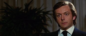 Movie still from “Frost/Nixon” (2008), directed by Ron Howard – A person wearing a suit and tie; Close Up shot, Over the shoulder angle