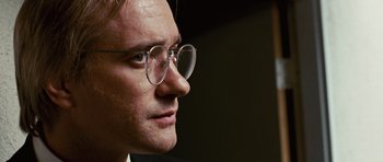 Movie still from “Frost/Nixon” (2008), directed by Ron Howard – A person wearing glasses; Close Up shot, Over the shoulder angle