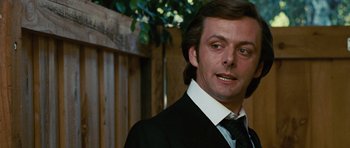 Movie still from “Frost/Nixon” (2008), directed by Ron Howard – A person wearing a suit and tie; Close Up shot, Over the shoulder angle