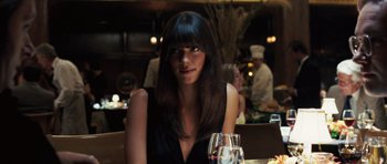 Movie still from “Frost/Nixon” (2008), directed by Ron Howard – A woman sitting at a table with a glass of wine; Close Up shot, Over the shoulder angle