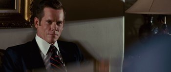 Movie still from “Frost/Nixon” (2008), directed by Ron Howard – A person wearing a suit and tie; Close Up shot, Over the shoulder angle