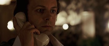 Movie still from “Frost/Nixon” (2008), directed by Ron Howard – A person talking on a phone; Close Up shot, Low angle