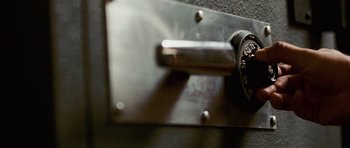 Movie still from “Frost/Nixon” (2008), directed by Ron Howard – View of a combination lock on a door knob; Extreme Close Up shot, High angle