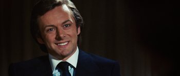 Movie still from “Frost/Nixon” (2008), directed by Ron Howard – A person wearing a suit and tie; Close Up shot, Over the shoulder angle