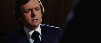 Movie still from “Frost/Nixon” (2008), directed by Ron Howard – A person wearing a suit and tie; Close Up shot, Over the shoulder angle