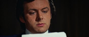 Movie still from “Frost/Nixon” (2008), directed by Ron Howard – A person wearing a suit and tie; Close Up shot, Low angle