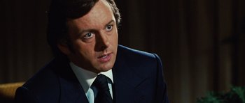 Movie still from “Frost/Nixon” (2008), directed by Ron Howard – A person wearing a suit and tie; Close Up shot, Over the shoulder angle