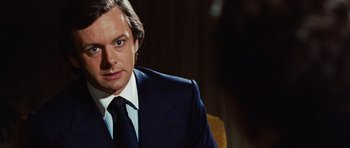 Movie still from “Frost/Nixon” (2008), directed by Ron Howard – A person wearing a suit and tie; Close Up shot, Over the shoulder angle