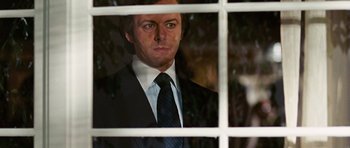 Movie still from “Frost/Nixon” (2008), directed by Ron Howard – A man wearing a suit and tie looking out a window; Close Up shot, Over the shoulder angle