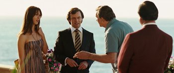 Movie still from “Frost/Nixon” (2008), directed by Ron Howard – A man in a business suit talking to another man in a business suit; Medium shot, Over the shoulder angle