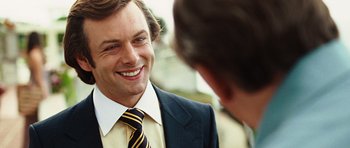 Movie still from “Frost/Nixon” (2008), directed by Ron Howard – A man in a suit and tie talking to another man in a suit and tie; Close Up shot, Over the shoulder angle