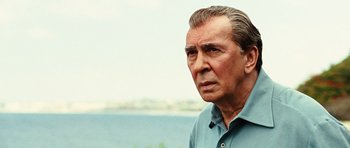 Movie still from “Frost/Nixon” (2008), directed by Ron Howard – An older man in a blue shirt looks at the camera; Close Up shot, Over the shoulder angle