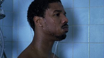 Movie still from “Fruitvale Station” (2013), directed by Ryan Coogler – A person taking a shower in a bathroom; Close Up shot, Low angle