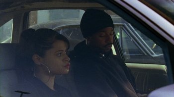 Movie still from “Fruitvale Station” (2013), directed by Ryan Coogler – A man and a woman sitting in the back of a car; Close Up shot, High angle