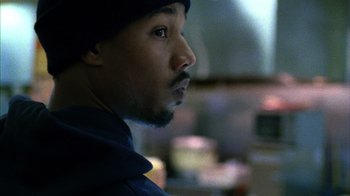 Movie still from “Fruitvale Station” (2013), directed by Ryan Coogler – A person wearing a hat; Close Up shot, Over the shoulder angle