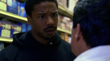 Movie still from “Fruitvale Station” (2013), directed by Ryan Coogler – A man in a black jacket talking to another man in a black jacket; Close Up shot, Over the shoulder angle