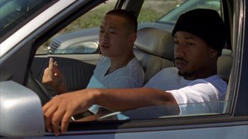Movie still from “Fruitvale Station” (2013), directed by Ryan Coogler – Two men sitting in the back seat of a car; Medium shot, High angle
