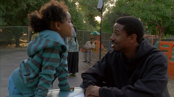 Movie still from “Fruitvale Station” (2013), directed by Ryan Coogler – A man and a little girl sitting at a table; Medium shot, Over the shoulder angle