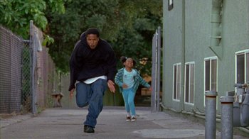 Movie still from “Fruitvale Station” (2013), directed by Ryan Coogler – A man and a little girl running down a street; Wide shot, Low angle