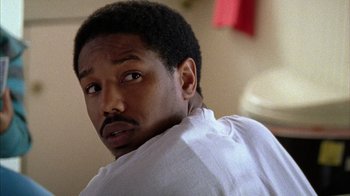 Movie still from “Fruitvale Station” (2013), directed by Ryan Coogler – A person wearing a white shirt; Close Up shot, Over the shoulder angle