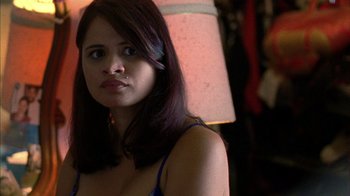 Movie still from “Fruitvale Station” (2013), directed by Ryan Coogler – A young woman with long dark brown hair and blue eyes; Close Up shot, Over the shoulder angle