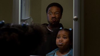 Movie still from “Fruitvale Station” (2013), directed by Ryan Coogler – A man and a little girl looking in a mirror; Close Up shot, Over the shoulder angle