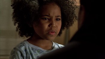 Movie still from “Fruitvale Station” (2013), directed by Ryan Coogler – A little girl with curly hair looking at the camera; Close Up shot, Over the shoulder angle