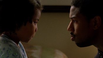Movie still from “Fruitvale Station” (2013), directed by Ryan Coogler – A man and a boy face to face in a room; Close Up shot, Over the shoulder angle