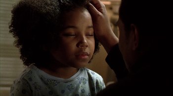 Movie still from “Fruitvale Station” (2013), directed by Ryan Coogler – A person touching a girl's hair with a hand; Close Up shot, Over the shoulder angle