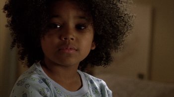 Movie still from “Fruitvale Station” (2013), directed by Ryan Coogler – A child with curly black hair; Close Up shot, High angle