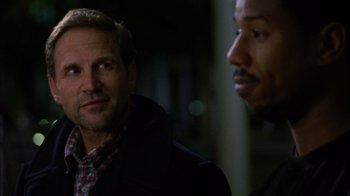 Movie still from “Fruitvale Station” (2013), directed by Ryan Coogler – A man and a man standing next to each other; Close Up shot, Over the shoulder angle