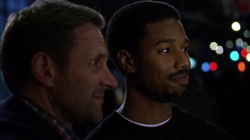 Movie still from “Fruitvale Station” (2013), directed by Ryan Coogler – Two men standing next to each other in front of a building; Close Up shot, Over the shoulder angle